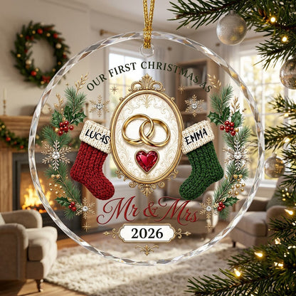 Round glass ornament with gold rings, red heart gem, red and green stockings, pine branches and Mr & Mrs text.