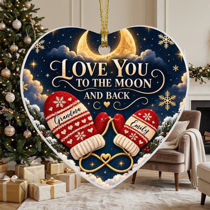 Heart ceramic ornament with golden crescent moon, red mittens, snowflakes and pine, personalized with two names.