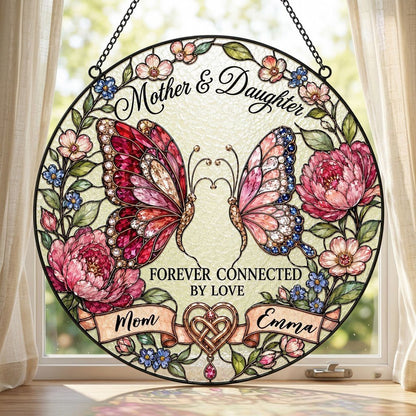 Round stained-glass style suncatcher with two butterflies, pink peonies and a ribbon banner for Mother & Daughter.