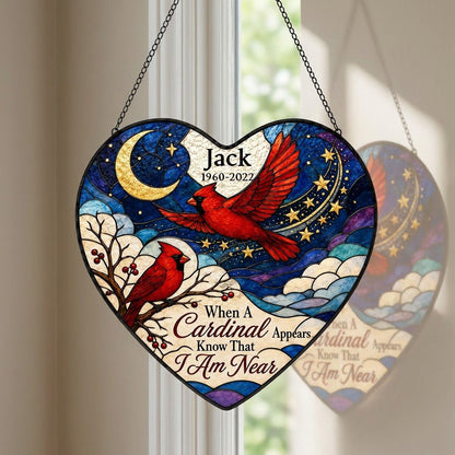 Heart stained-glass suncatcher with two red cardinals, a crescent moon, stars, and a branch with red berries.