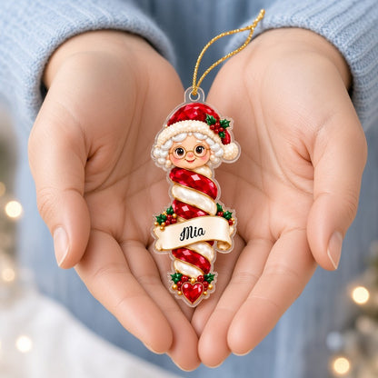 Custom-cut clear acrylic ornaments: a Christmas tree finial and a Mrs. Claus finial with cream name banners.