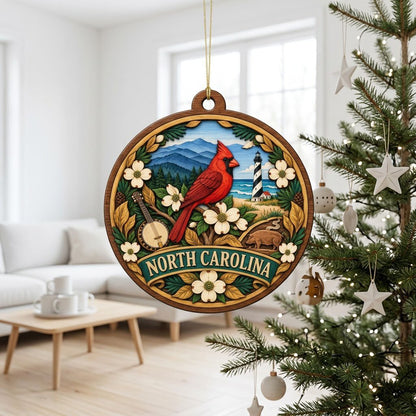 Round ornament with red cardinal, dogwood flowers, mountains, lighthouse, banjo, and 'NORTH CAROLINA' text.