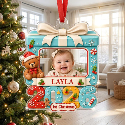 Light blue gift-box photo ornament with cream bow, teddy bear, red trim, and colorful 2026 base with 1st Christmas.