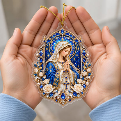 A custom-cut acrylic ornament of the Virgin Mary praying with a rosary, blue mantle, and ornate gold frame.