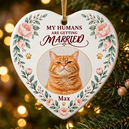 Heart ceramic ornament with 'My Humans Are Getting Married,' a cat photo, pink florals, gold paw prints, and a heart ico