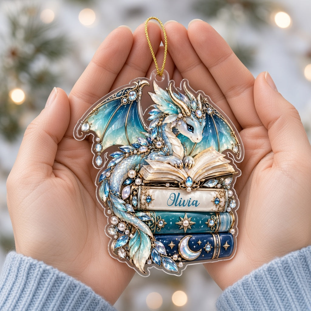 Custom-cut acrylic ornament of a jeweled blue dragon on stacked books with a red ribbon and a personalized name.