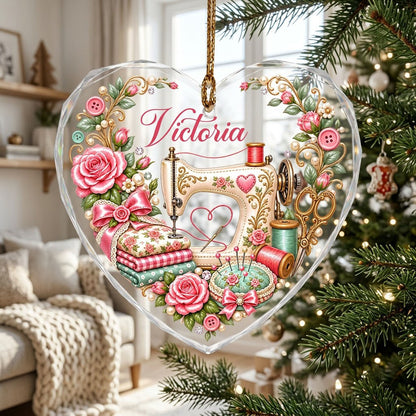 Heart-shaped glass ornament with vintage cream sewing machine, pink roses, buttons, and a personalized name.