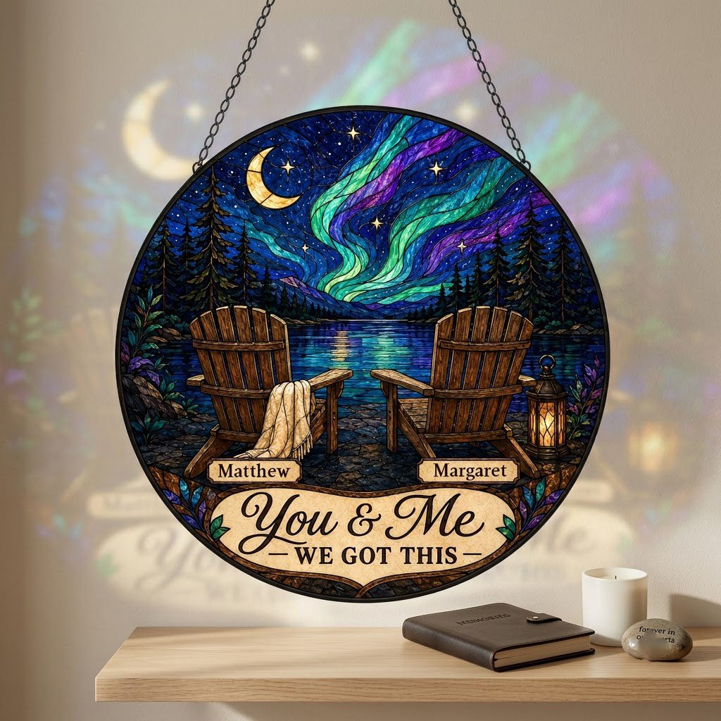 Round stained-glass style suncatcher with aurora, crescent moon, pine trees, lake, two chairs and a lantern.