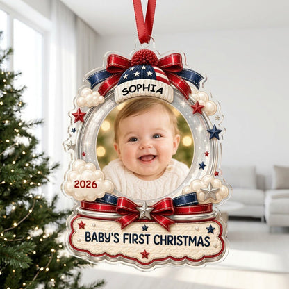 Custom-cut acrylic ornament with baby's photo, patriotic beanie, red bows, stars, and 'Baby's First Christmas' banner.