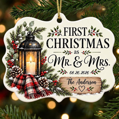 Medallion ceramic ornament with black lantern, pine, red berries, plaid scarf, and 'FIRST CHRISTMAS as MR. & MRS.' text.