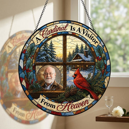 Stained glass suncatcher with a wooden four-pane window, snowy cabin scene, red cardinal on pine branches, and a circula