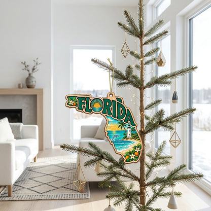 Florida state wood ornament with "FLORIDA", beach waves, dolphin, lighthouse, palm trees, and orange blossoms.