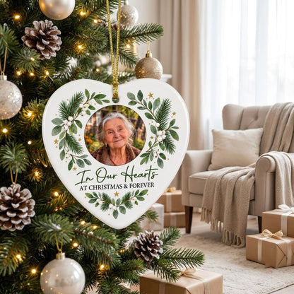 Heart ceramic ornament with In Our Hearts and AT CHRISTMAS & FOREVER around a circular photo frame with green foliage.