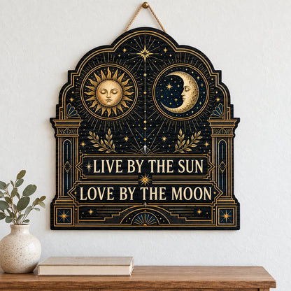 Arched wooden sign with sun and moon faces, constellations, and 'Live By The Sun, Love By The Moon'.