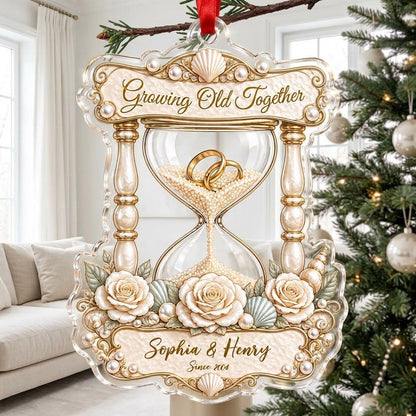Acrylic hourglass ornament with gold rings, roses, seashells, pearls, and Growing Old Together text.