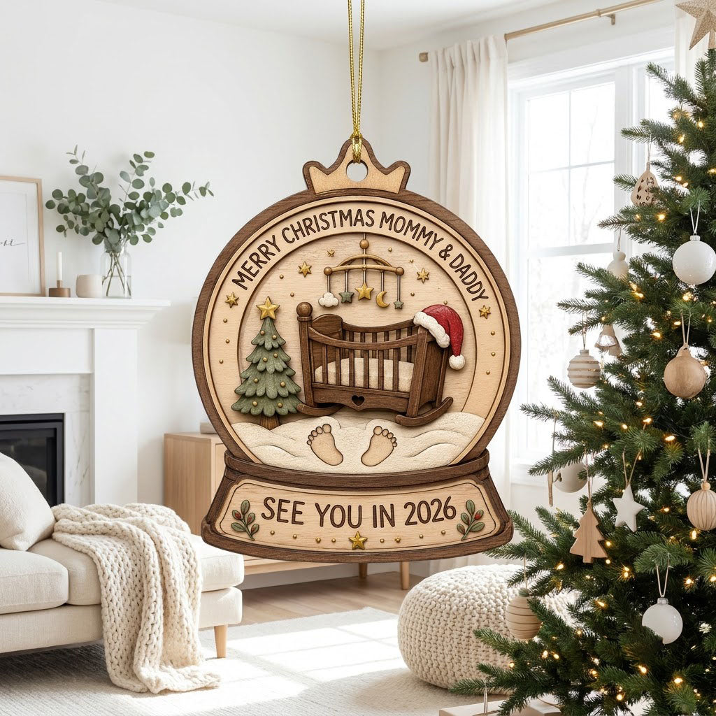 Snow globe wood ornament with crib, Santa hat, mobile, tree, footprints, and Merry Christmas Mommy & Daddy text.