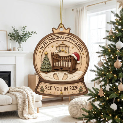Snow globe wood ornament with crib, Santa hat, mobile, tree, footprints, and Merry Christmas Mommy & Daddy text.