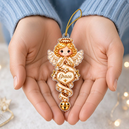Acrylic angel and gingerbread ornaments with jeweled ribbons, heart or star name banners, and gold bells.