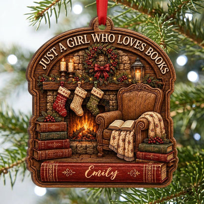 Wood ornament with fireplace, wreath, stockings, armchair and books, plus 'Just a Girl Who Loves Books' and a name.