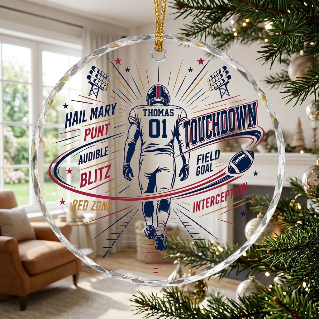 Round faceted glass ornament with football player back view, stadium lights, navy swoosh, and name and number.