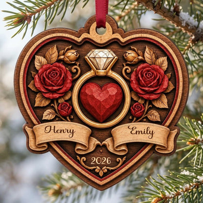 Heart-shaped wood ornament with a gold ring, red heart, red roses, and names Henry and Emily with year 2026.