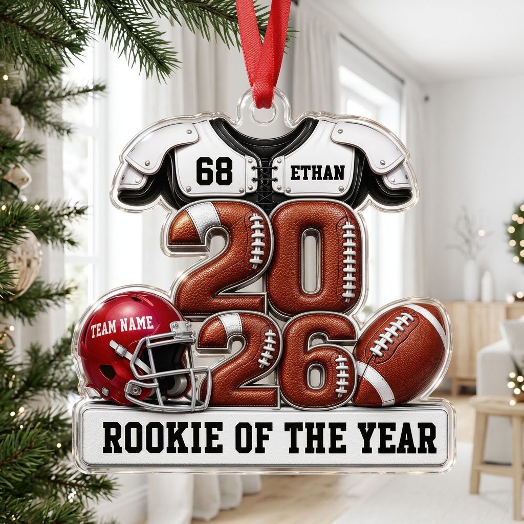 Acrylic ornament shaped like football gear with 2026 numbers, red helmet, ball and 'Rookie of the Year' nameplate.