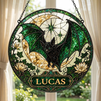 Round stained-glass style suncatcher with black bat, green wings, crescent moon, ivy, white flowers, and a personalized 