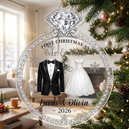 Clear acrylic diamond-ring ornament with tuxedo, lace gown, silver rings and 'First Christmas as Mr. & Mrs.' text.