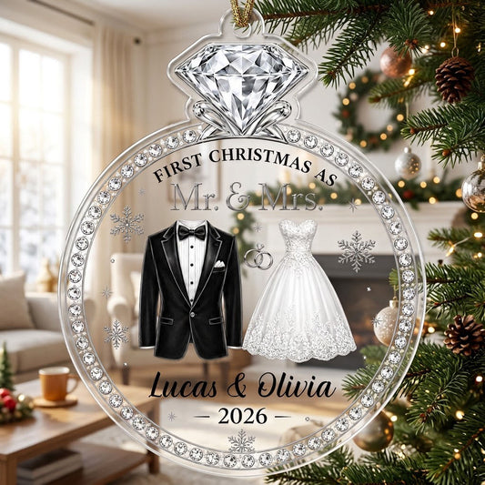 Clear acrylic diamond-ring ornament with tuxedo, lace gown, silver rings and 'First Christmas as Mr. & Mrs.' text.