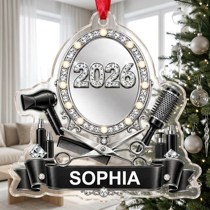 Clear acrylic ornament with a lit vanity mirror and salon tools, featuring SOPHIA and 2026 on a black banner.