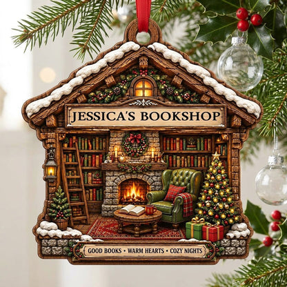 House-shaped wood ornament with cozy bookshop scene, fireplace, bookshelves, and a lit Christmas tree.