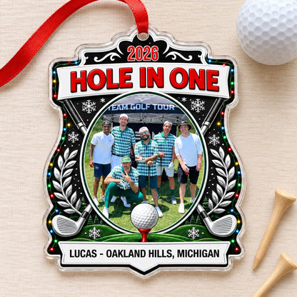 Acrylic crest ornament with golf photo, crossed clubs, Christmas lights, snowflakes, and HOLE IN ONE 2026 text.