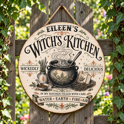 Round wooden hanging sign with a bubbling cauldron, herbs, spellbook, stars and the words Witch's Kitchen.