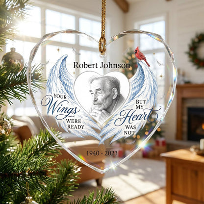 Heart-shaped glass ornament with blue angel wings, red cardinal, and a memorial quote with name and years.