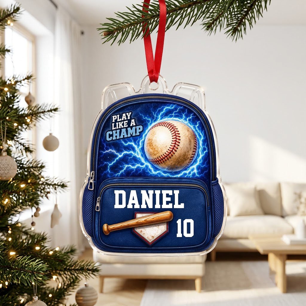 Backpack-shaped acrylic ornament with a baseball, blue lightning, a bat on home plate, and PLAY LIKE A CHAMP text.