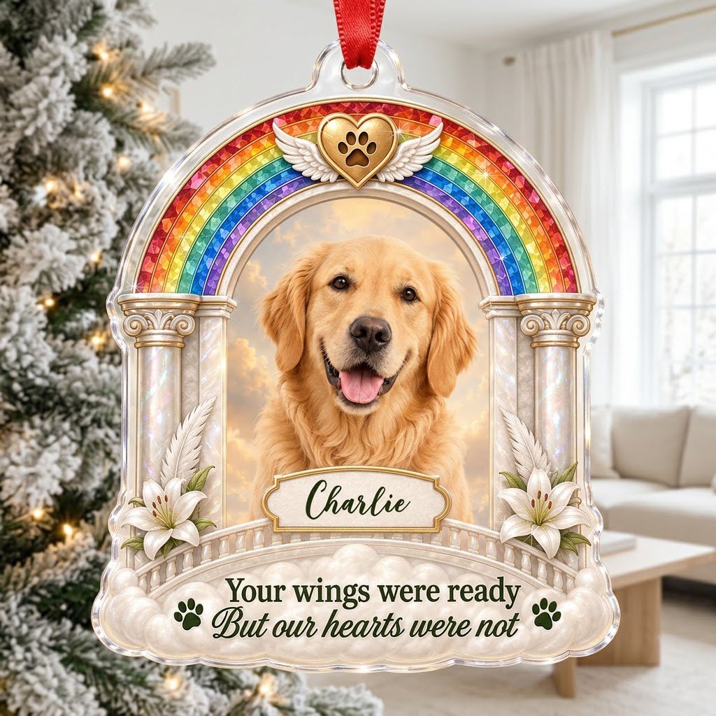 A rainbow arch pet memorial acrylic ornament with a winged golden heart, paw print, lilies, pillars, clouds and a photo 