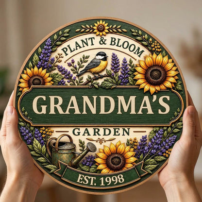 Round wooden sign with sunflowers, lavender, a chickadee, and green banners reading PLANT & BLOOM and GARDEN.