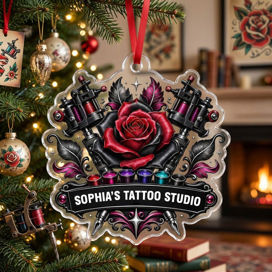 Clear acrylic ornament with red and black rose, crossed tattoo machines, caps, and SOPHIA'S TATTOO STUDIO text.