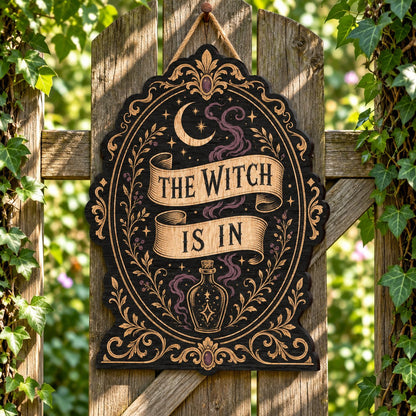 Gothic plaque sign reading "THE WITCH IS IN" with crescent moon, stars, purple smoke, potion bottle and ornate filigree 