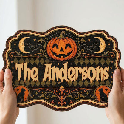 Ornate scalloped wooden sign with jack-o'-lantern, moons, bats, black cats and family name in Halloween style.