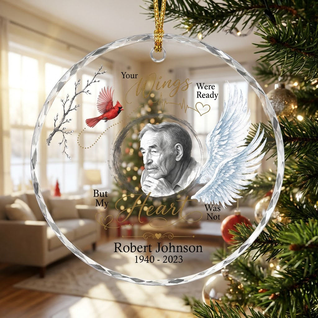 Round glass ornament with a sketch portrait frame, blue angel wing, red cardinal and 'Your Wings Were Ready' memorial te
