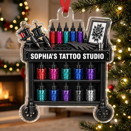 Acrylic ornament shaped like a tattoo cart with machines, colorful inks, and 'SOPHIA'S TATTOO STUDIO' text.