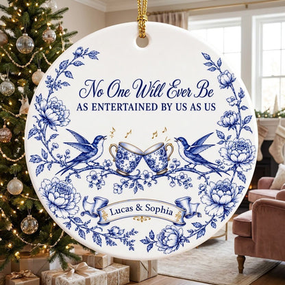 Round ceramic ornament with blue toile border, two birds, clinking floral teacups and gold music notes with two names.