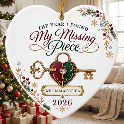 Heart ceramic ornament with a gold key through a burgundy and green heart lock, pine sprigs, berries, and gold snowflake