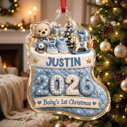 Blue quilted stocking ornament with teddy bear, baby toys, Baby's 1st Christmas text, and name and year.