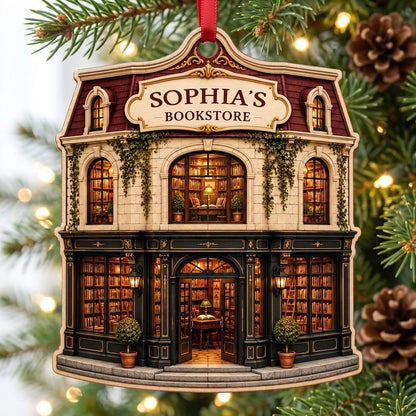 Custom-cut ornament shaped like a vintage bookstore with green and gold storefront and 'BOOKSTORE' text personalized abo