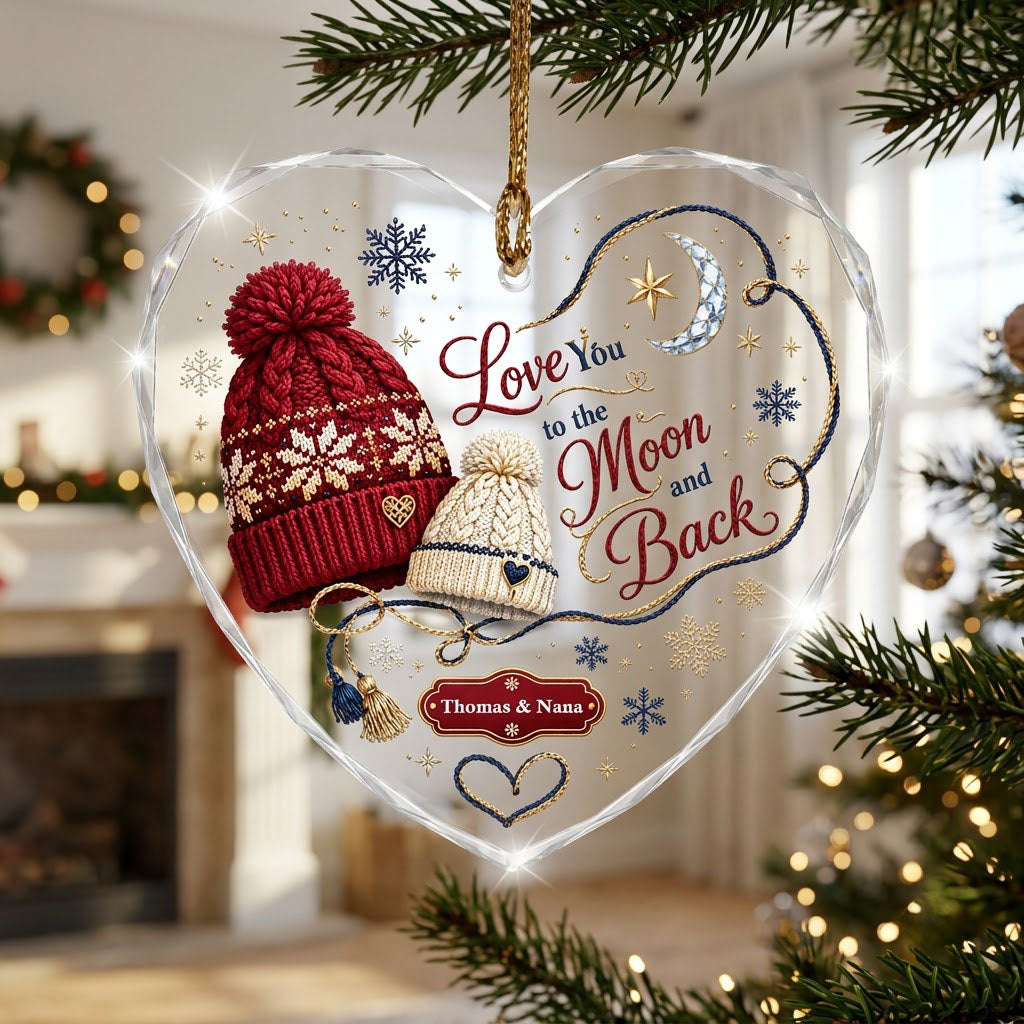 Heart glass ornament with red and cream pom-pom beanies, silver moon, gold star, and Love You Moon and Back text.