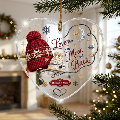 Heart glass ornament with red and cream pom-pom beanies, silver moon, gold star, and Love You Moon and Back text.