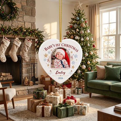 Heart ceramic ornament with arched photo frame, gold stars, blue snowflakes, holly, and 'Baby's 1st Christmas' text.