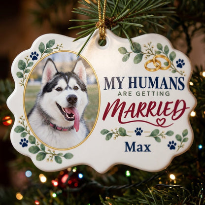 Scalloped medallion ornament with dog photo, eucalyptus, paw prints, and 'MY HUMANS ARE GETTING MARRIED' text.